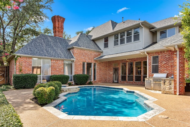 3928 Dove Creek Ln, Plano, TX 75093 - back of property featuring area for grilling, brick siding, an outdoor pool, and a shingled roof