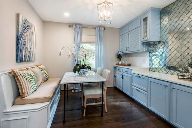 8803 Westglen Dr, Dallas, TX 75228 - kitchen with decorative backsplash, dark wood-style floors, light countertops, glass insert cabinets, and a chandelier