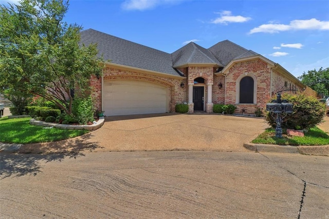 3804 Park Flower Ct, Arlington, TX 76017 - french country inspired facade featuring brick siding, driveway, a garage, and roof with shingles