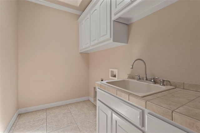 3804 Park Flower Ct, Arlington, TX 76017 - laundry room with cabinet space, hookup for a washing machine, ornamental molding, and light tile patterned flooring