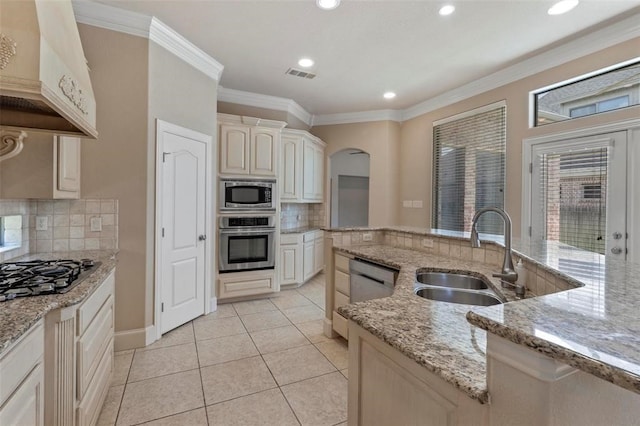 3804 Park Flower Ct, Arlington, TX 76017 - kitchen featuring appliances with stainless steel finishes, custom range hood, decorative backsplash, ornamental molding, and light tile patterned floors