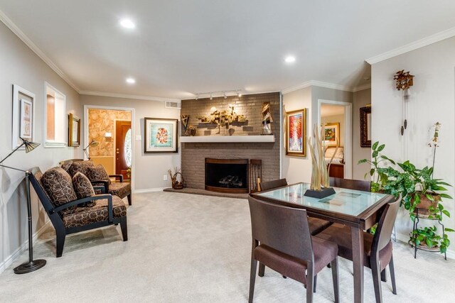 5715 Northaven Rd, Dallas, TX 75230 - dining space with light carpet, a brick fireplace, ornamental molding, and recessed lighting
