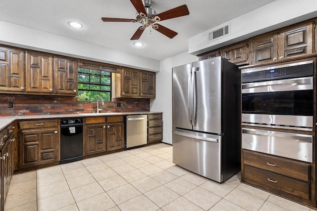 2214 Parkside Dr, Denton, TX 76201 - kitchen featuring stainless steel appliances, a warming drawer, ceiling fan, tasteful backsplash, and light tile patterned flooring