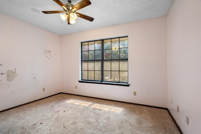 2214 Parkside Dr, Denton, TX 76201 - carpeted empty room featuring ceiling fan and a textured ceiling