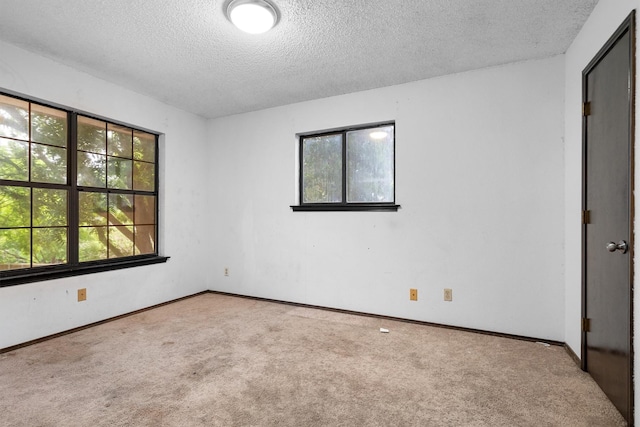 2214 Parkside Dr, Denton, TX 76201 - carpeted empty room with a textured ceiling and baseboards