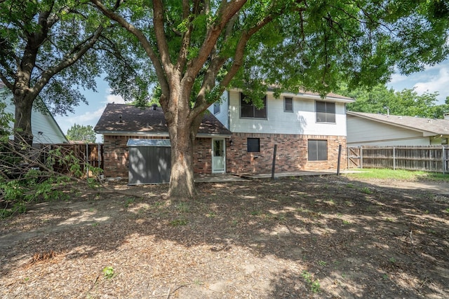 2214 Parkside Dr, Denton, TX 76201 - back of house with brick siding and a fenced backyard
