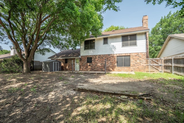 2214 Parkside Dr, Denton, TX 76201 - back of property featuring a storage shed, brick siding, a fenced backyard, and a chimney