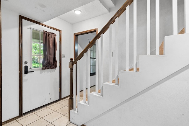 2214 Parkside Dr, Denton, TX 76201 - entrance foyer featuring stairs, light tile patterned floors, and a textured ceiling