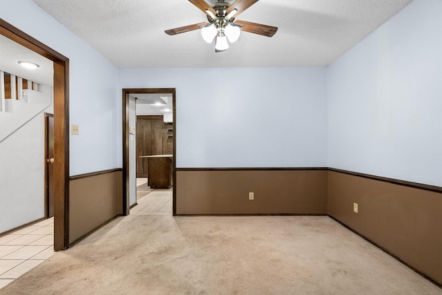 2214 Parkside Dr, Denton, TX 76201 - empty room featuring ceiling fan, a textured ceiling, and light colored carpet