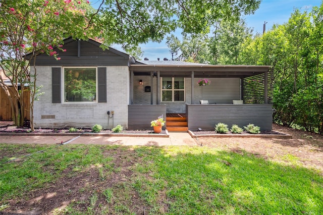 2711 El Tivoli Dr, Dallas, TX 75211 - ranch-style house featuring a porch, a front yard, and brick siding