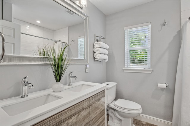 2711 El Tivoli Dr, Dallas, TX 75211 - full bathroom featuring double vanity, a shower with curtain, and wood finished floors