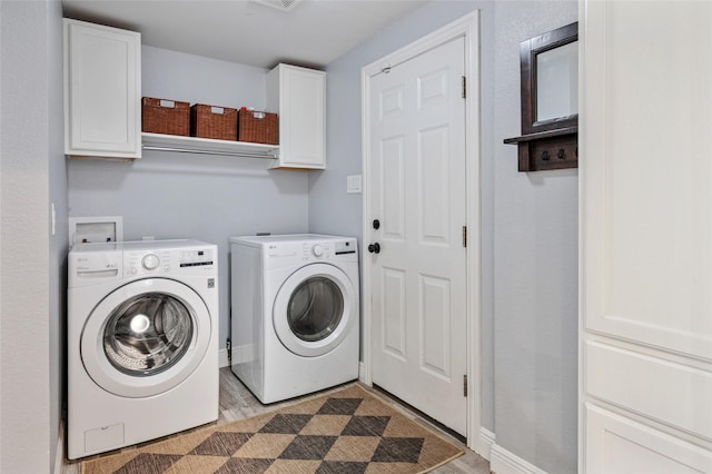 2711 El Tivoli Dr, Dallas, TX 75211 - laundry area featuring cabinet space, washer and dryer, and light wood finished floors