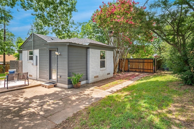 2711 El Tivoli Dr, Dallas, TX 75211 - back of property featuring brick siding, crawl space, a patio, and an outdoor structure