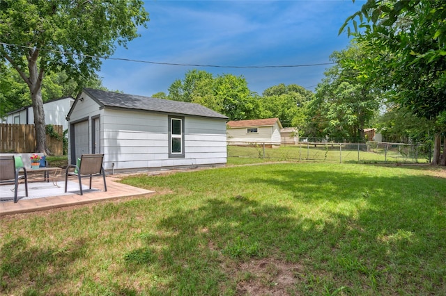 2711 El Tivoli Dr, Dallas, TX 75211 - fenced backyard featuring an outbuilding, a garage, and a patio
