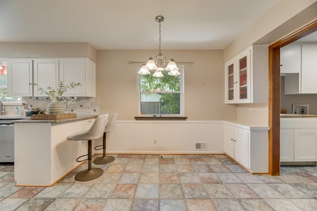 13861 Far Hills Ln, Dallas, TX 75240 - kitchen with plenty of natural light, stainless steel dishwasher, and white cabinets