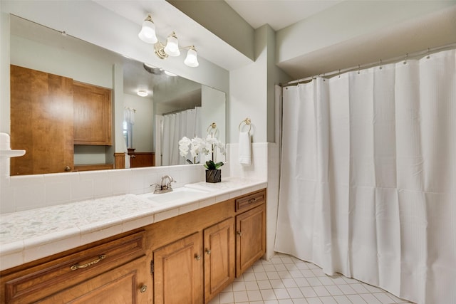 13861 Far Hills Ln, Dallas, TX 75240 - bathroom featuring vanity, tile patterned floors, and backsplash