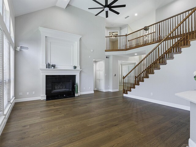 925 Canongate Dr, Flower Mound, TX 75022 - unfurnished living room with ceiling fan, high vaulted ceiling, stairs, a tile fireplace, and wood finished floors