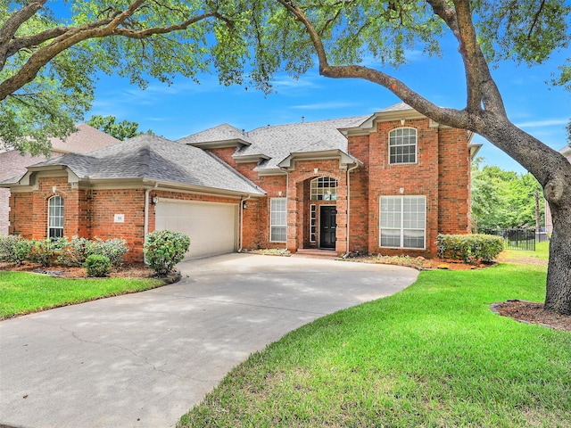 925 Canongate Dr, Flower Mound, TX 75022 - traditional-style home with brick siding, an attached garage, a shingled roof, and driveway