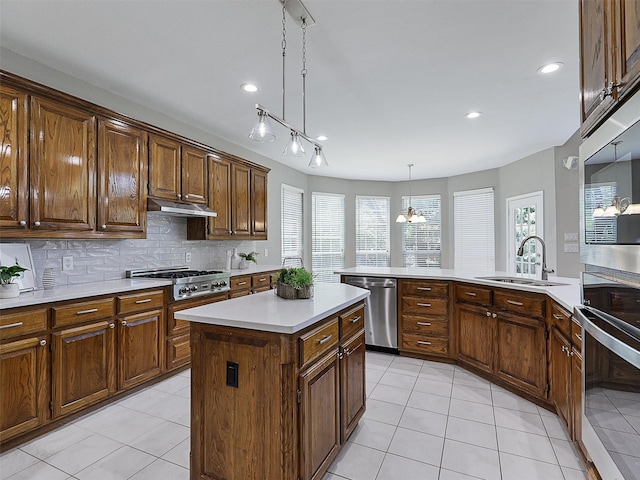 925 Canongate Dr, Flower Mound, TX 75022 - kitchen featuring appliances with stainless steel finishes, light tile patterned flooring, under cabinet range hood, light countertops, and a center island
