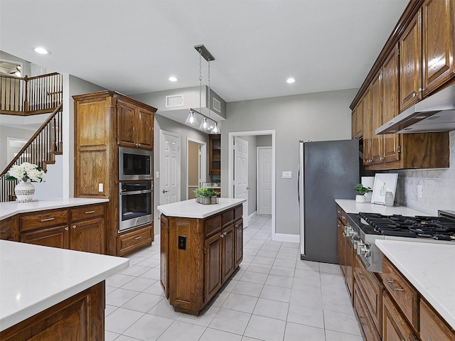 925 Canongate Dr, Flower Mound, TX 75022 - kitchen featuring appliances with stainless steel finishes, light countertops, under cabinet range hood, light tile patterned flooring, and recessed lighting