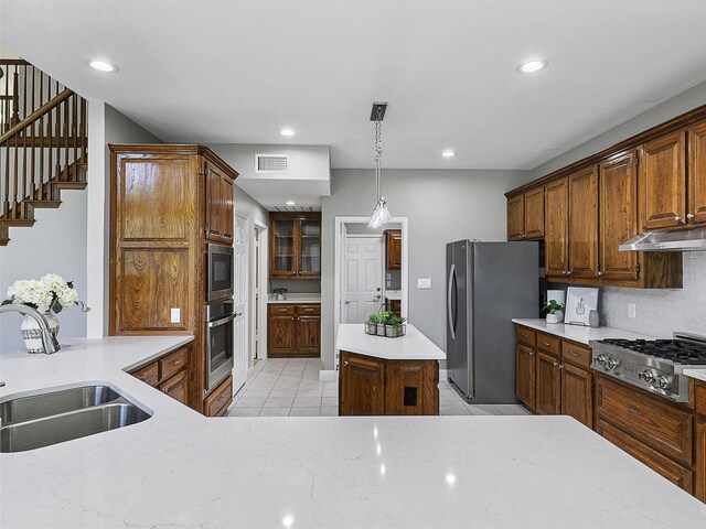 925 Canongate Dr, Flower Mound, TX 75022 - kitchen featuring stainless steel appliances, light tile patterned flooring, under cabinet range hood, recessed lighting, and backsplash