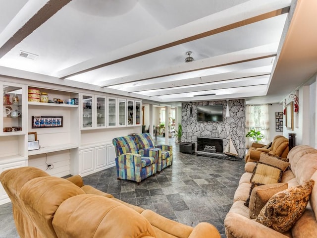 405 Chandler Lake Rd, Fort Worth, TX 76103 - living room featuring a fireplace, stone finish flooring, and beam ceiling
