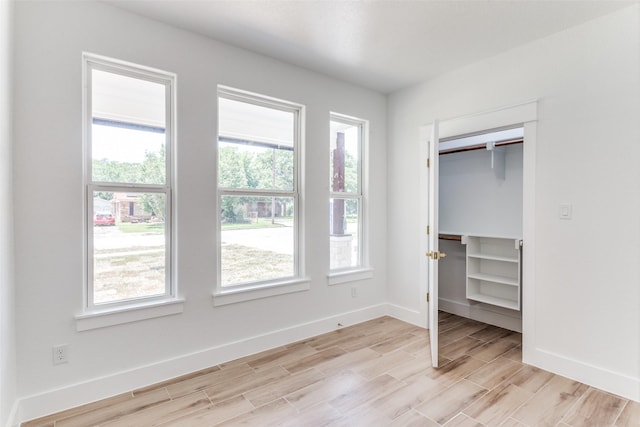 3020 Pueblo Trl, Lake Worth, TX 76135 - unfurnished bedroom featuring light wood-type flooring and a walk in closet