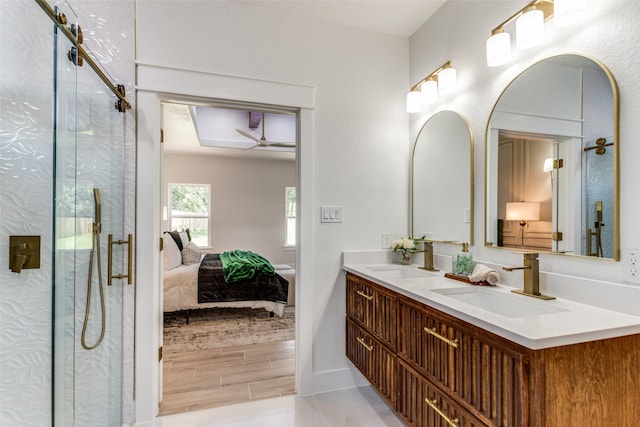 3020 Pueblo Trl, Lake Worth, TX 76135 - ensuite bathroom featuring ceiling fan, double vanity, a marble finish shower, and wood finished floors