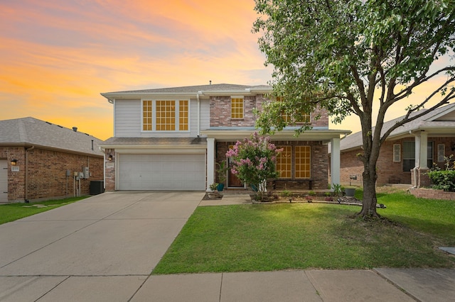13341 Ridgepointe Rd, Fort Worth, TX 76244 - traditional home featuring a garage, driveway, a front lawn, and brick siding