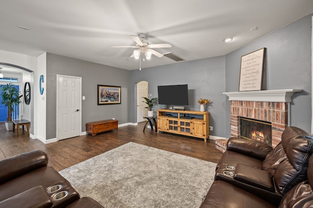 13341 Ridgepointe Rd, Fort Worth, TX 76244 - living room with arched walkways, a ceiling fan, wood finished floors, and a fireplace