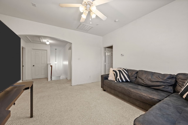 13341 Ridgepointe Rd, Fort Worth, TX 76244 - living room with a ceiling fan, light colored carpet, arched walkways, and attic access