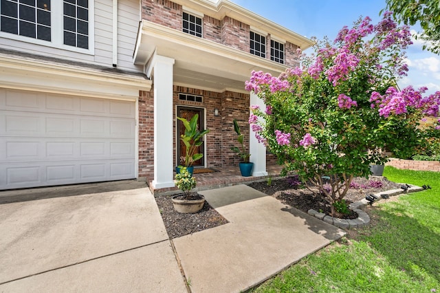 13341 Ridgepointe Rd, Fort Worth, TX 76244 - property entrance featuring brick siding, an attached garage, driveway, and a yard