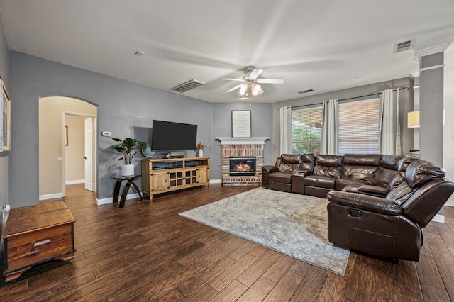 13341 Ridgepointe Rd, Fort Worth, TX 76244 - living area with a ceiling fan, dark wood finished floors, arched walkways, and a brick fireplace