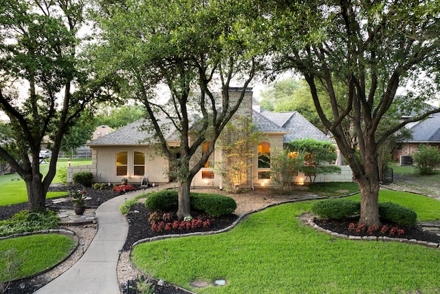 1450 Meandering Way, Rockwall, TX 75087 - view of front of home with a front lawn, a shingled roof, and stucco siding