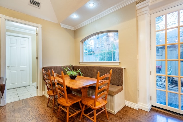 1450 Meandering Way, Rockwall, TX 75087 - dining space featuring ornamental molding, wood finished floors, plenty of natural light, lofted ceiling, and recessed lighting