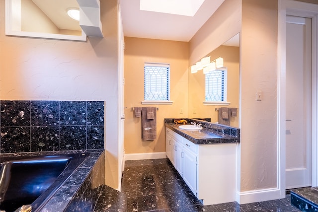 1450 Meandering Way, Rockwall, TX 75087 - bathroom with vanity, a bath, and a skylight