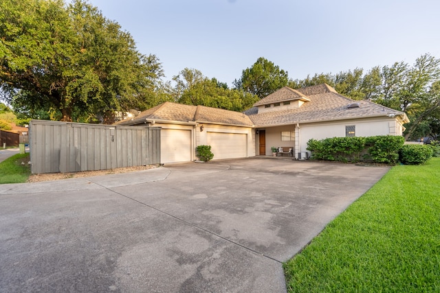 1450 Meandering Way, Rockwall, TX 75087 - view of front of house with a garage, concrete driveway, stucco siding, a front yard, and a shingled roof