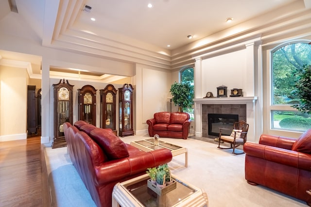 1450 Meandering Way, Rockwall, TX 75087 - living area featuring a tiled fireplace, healthy amount of natural light, a raised ceiling, and recessed lighting