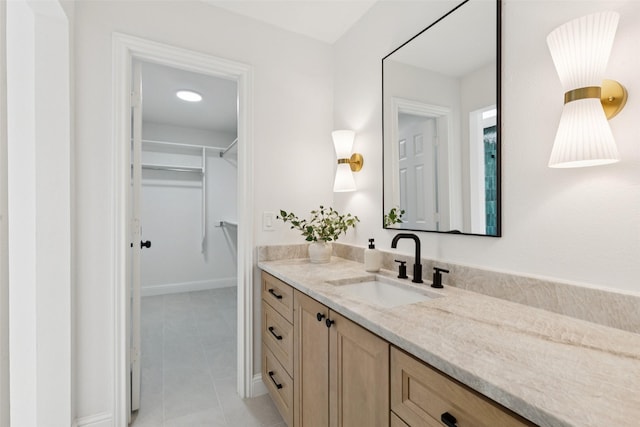 1100 Longworth Dr, Plano, TX 75075 - bathroom featuring vanity, a walk in closet, and tile patterned flooring