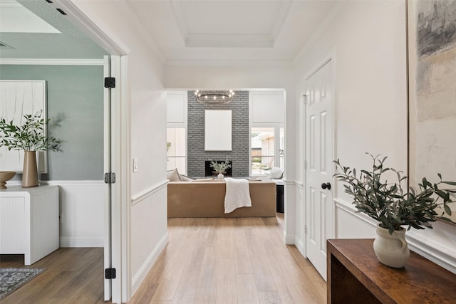 1100 Longworth Dr, Plano, TX 75075 - hallway featuring light wood-type flooring, a raised ceiling, a chandelier, and ornamental molding