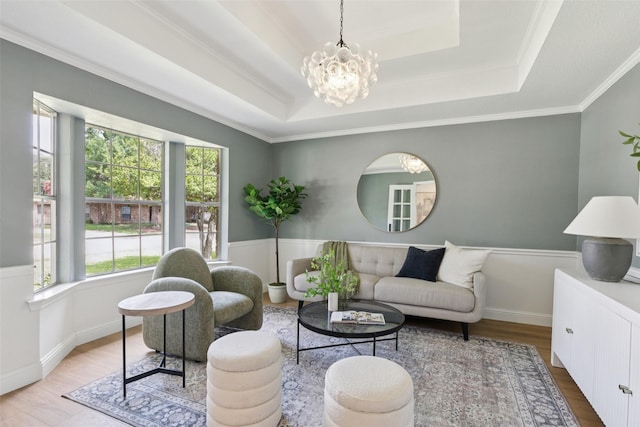 1100 Longworth Dr, Plano, TX 75075 - living area featuring a tray ceiling, healthy amount of natural light, wood finished floors, a chandelier, and ornamental molding