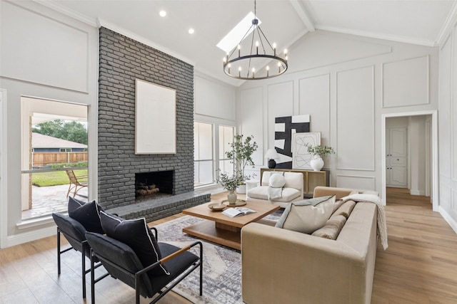 1100 Longworth Dr, Plano, TX 75075 - living room with a decorative wall, a chandelier, a brick fireplace, light wood-type flooring, and high vaulted ceiling