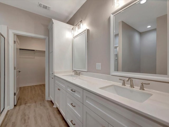 106 Saddle Brook Dr, Lufkin, TX 75904 - full bathroom with double vanity, wood finished floors, and a spacious closet