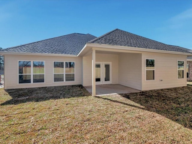 106 Saddle Brook Dr, Lufkin, TX 75904 - back of property with roof with shingles, a lawn, and a patio
