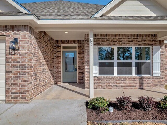 106 Saddle Brook Dr, Lufkin, TX 75904 - doorway to property with brick siding and roof with shingles