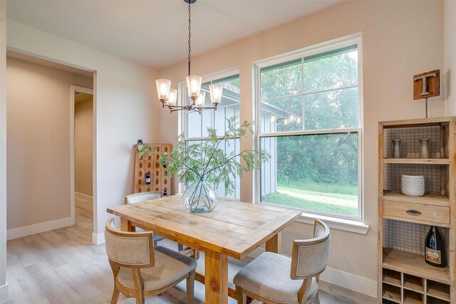 619 Latigo Ct, Weatherford, TX 76088 - dining room featuring a chandelier and wood finished floors