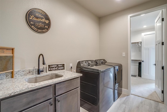619 Latigo Ct, Weatherford, TX 76088 - laundry area with washer and dryer, cabinet space, light wood-style floors, and recessed lighting