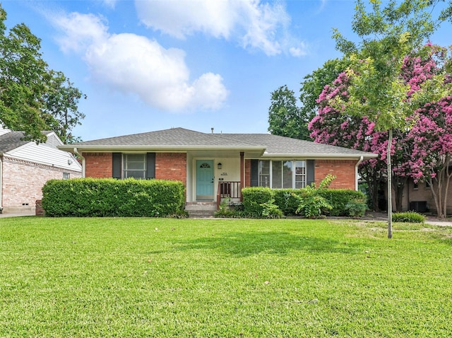 721 Sherwood Dr, Richardson, TX 75080 - view of front of house featuring a front yard, brick siding, and a shingled roof