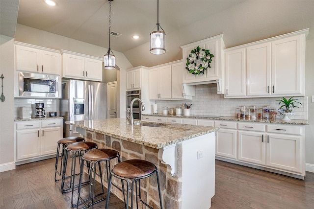 404 Bluffside Trl, Benbrook, TX 76126 - kitchen with stainless steel appliances, backsplash, white cabinetry, dark wood-style floors, and lofted ceiling