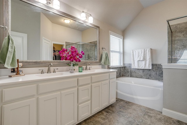 404 Bluffside Trl, Benbrook, TX 76126 - full bath with lofted ceiling, double vanity, a walk in closet, a bath, and a stall shower